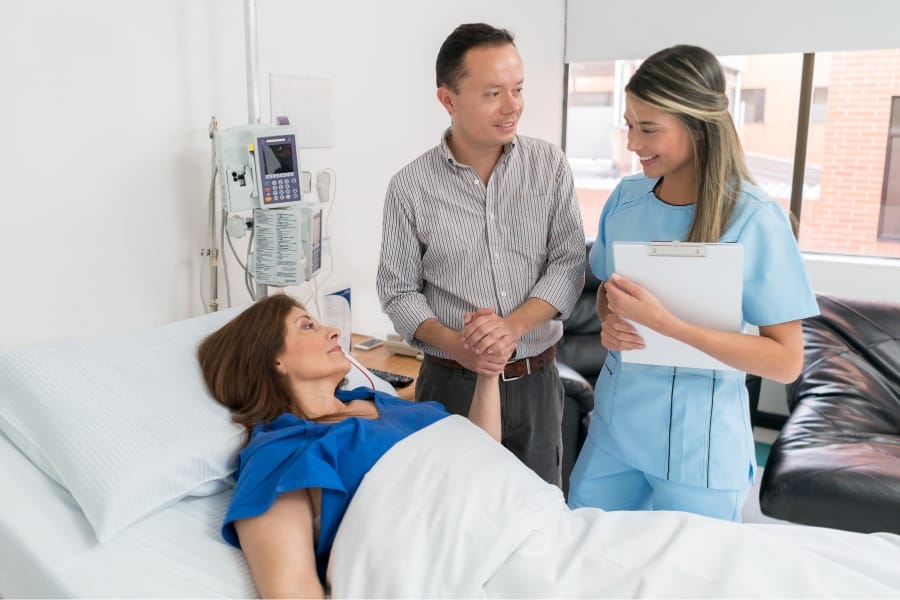 nurse checking in on her patient and her husband