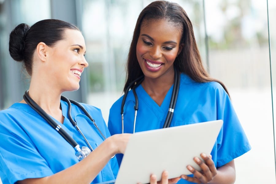 Two nurses discussing a patient's chart