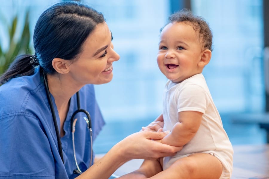 Pediatric nurse with a small baby