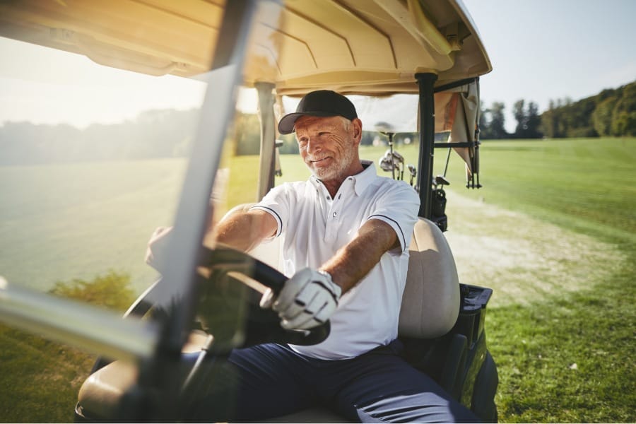 Middle aged man golfing