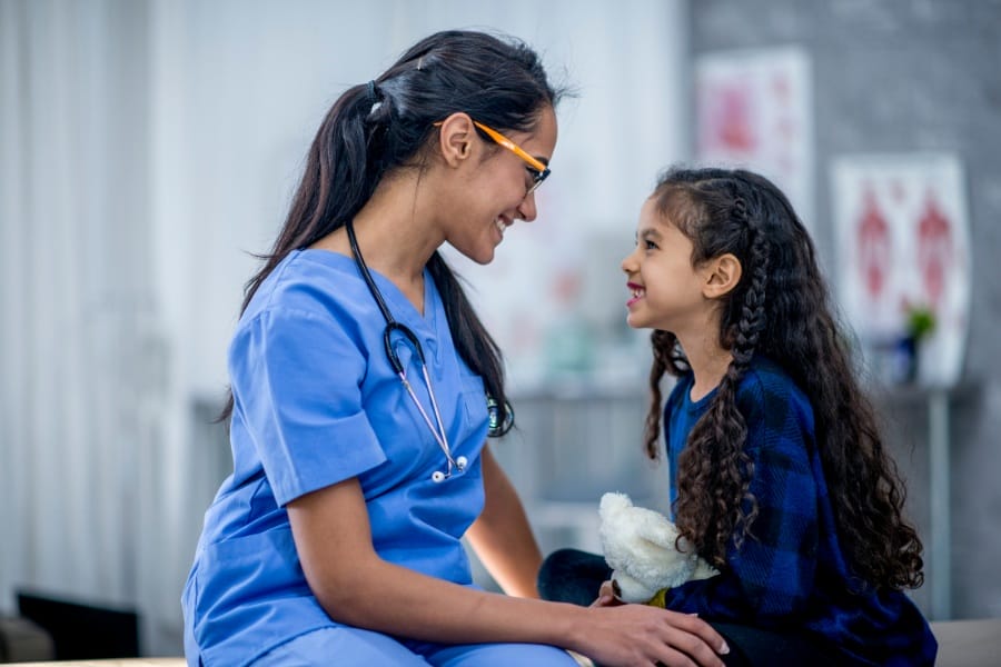 Pediatric nurse with a young patient