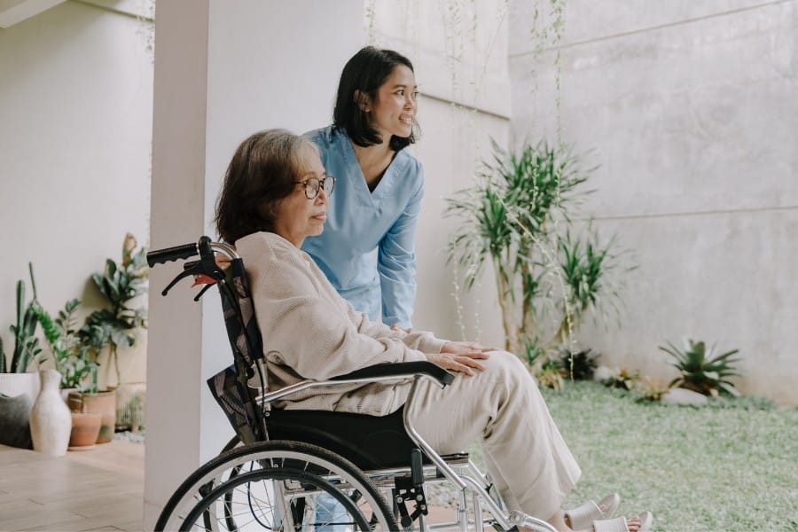 private duty nurse and a patient in a wheelchair