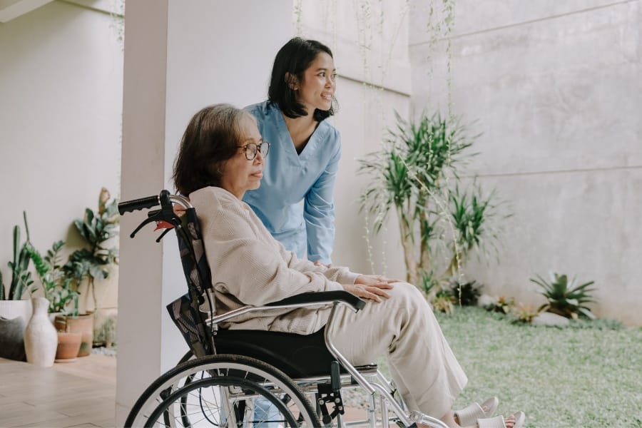 private nurse and her elderly client in a wheelchair