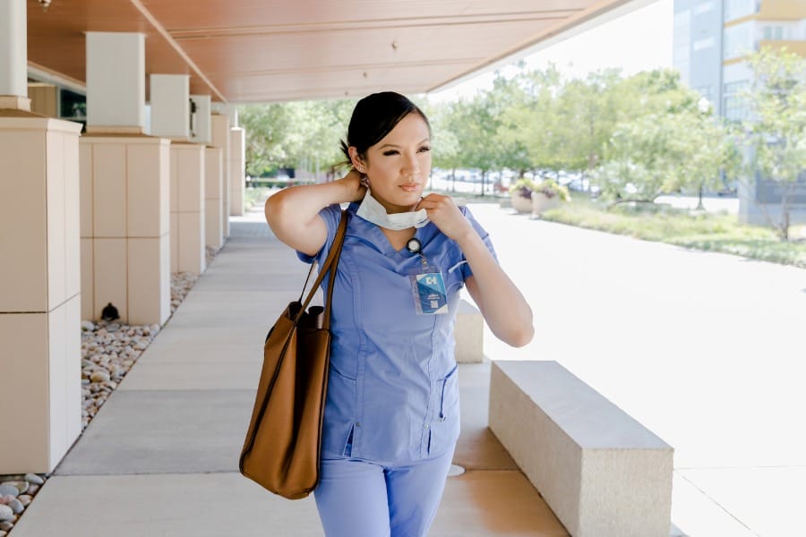 home health nurse putting on her mask