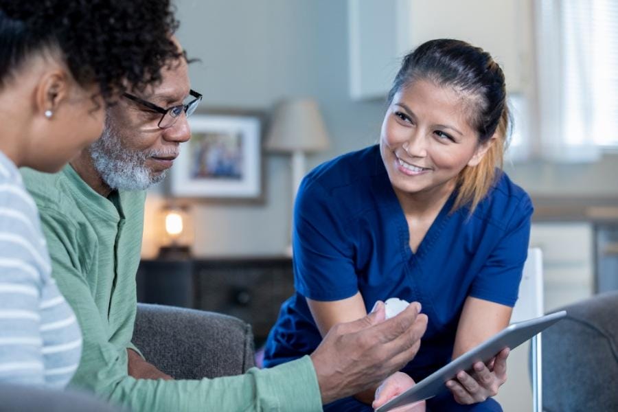 Smiling private duty nurse assisting her patients