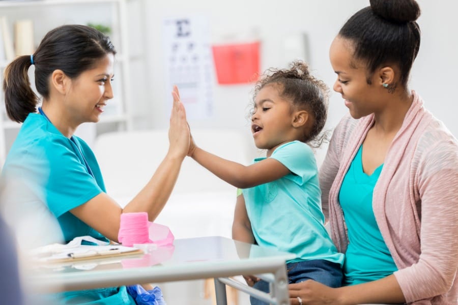 pediatric nurse and her young patient