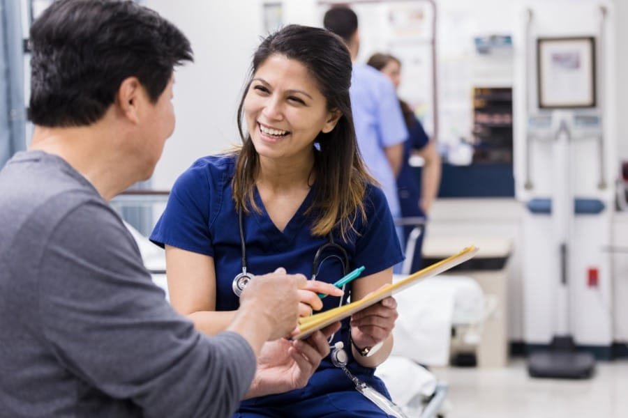 RN assisting a patient with his medical record