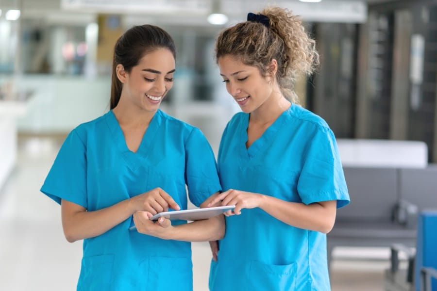 Two nurses chatting in a Boynton Beach healthcare facility