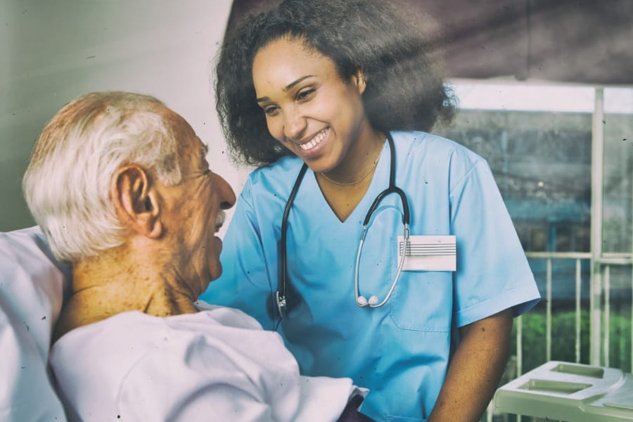 Smiling RN and her elderly patient