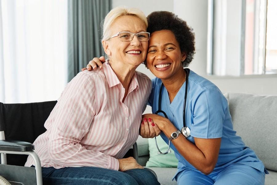 Smiling client and her private nurse offering concierge medicine