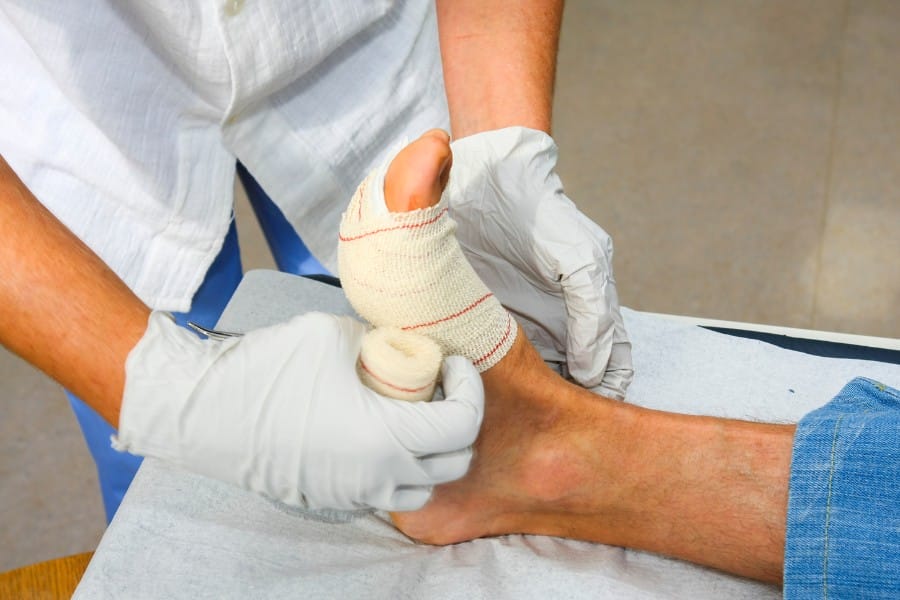 LA postoperative nurse wrapping a foot