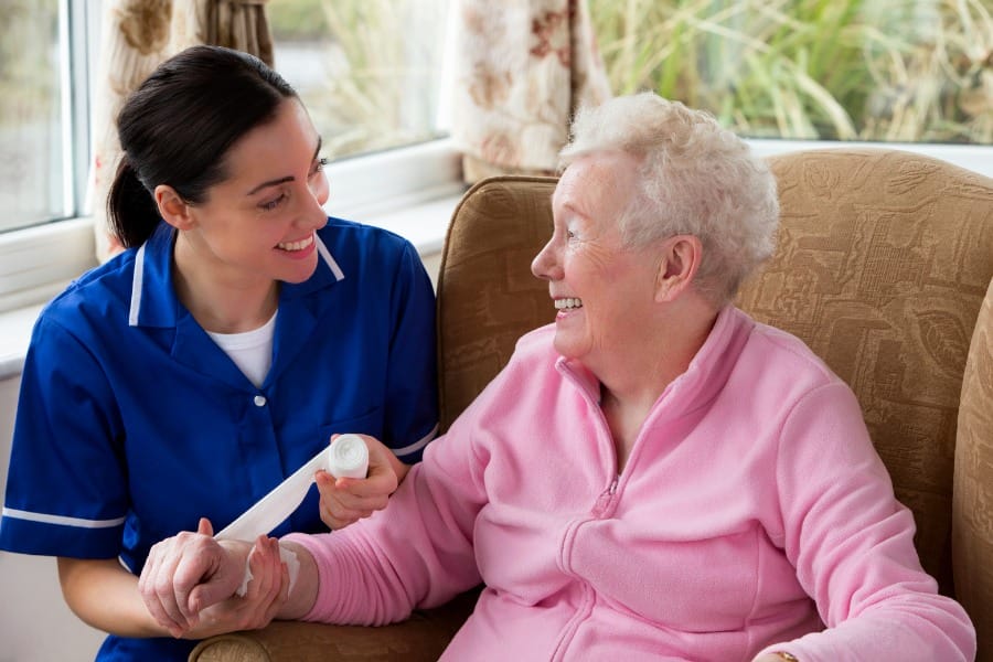 post op nurse dressing a wound