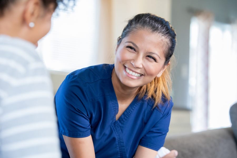 private nurse smiling with patient after egg retrieval