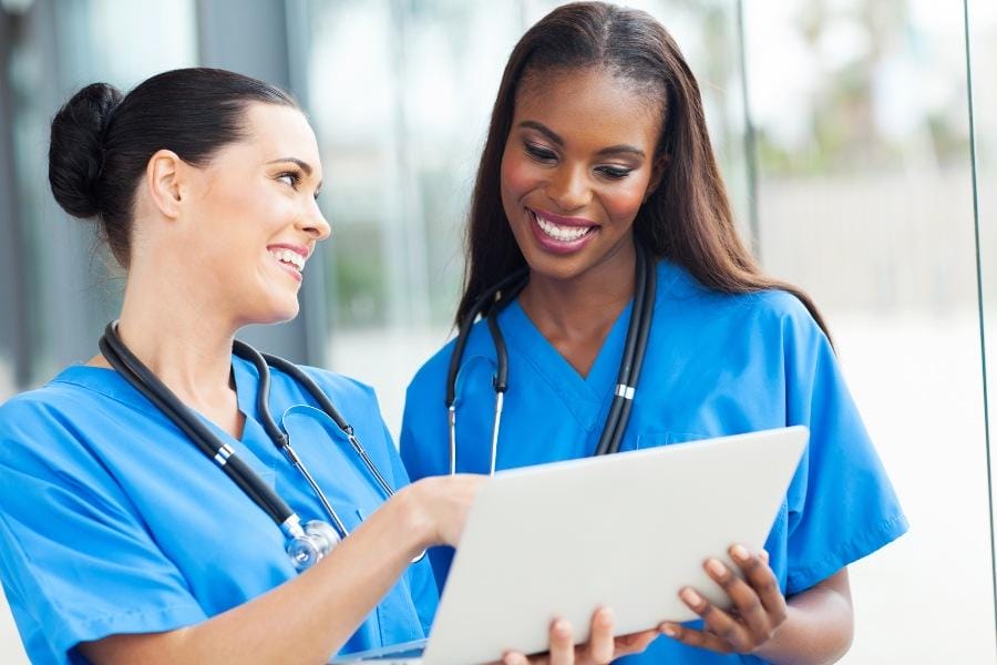 Two nurses discussing a patient's chart