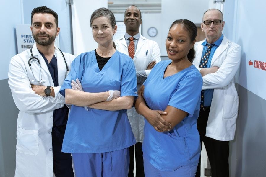 A group of nurses smiling in a hospital