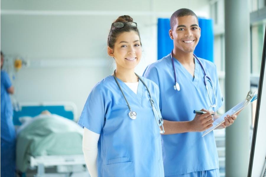 Two nurses smiling in a healthcare facility