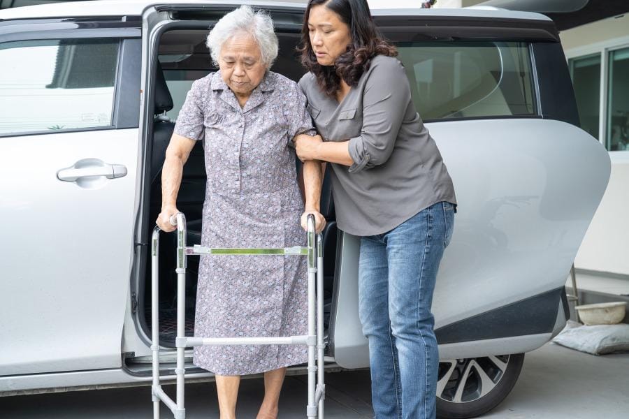 A woman with MS receiving help