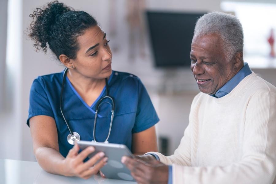A nurse sharing her patient's records with him