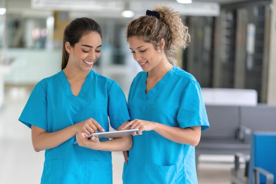 two per diem nurses talking in a healthcare facility