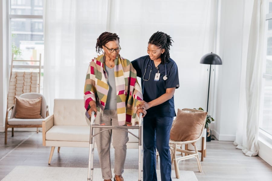 nurse assisting an elderly client