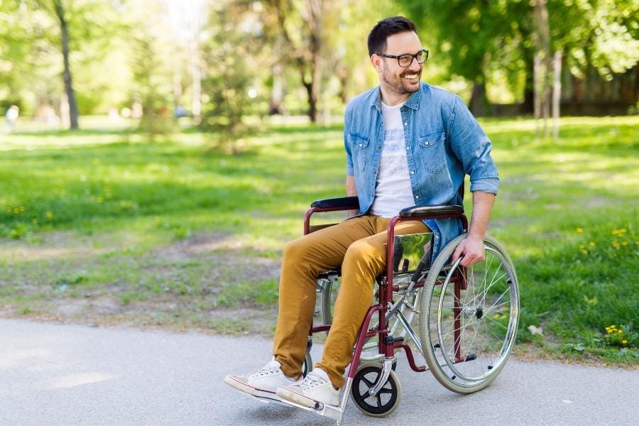 Young main in a wheelchair after having knee replacement surgery