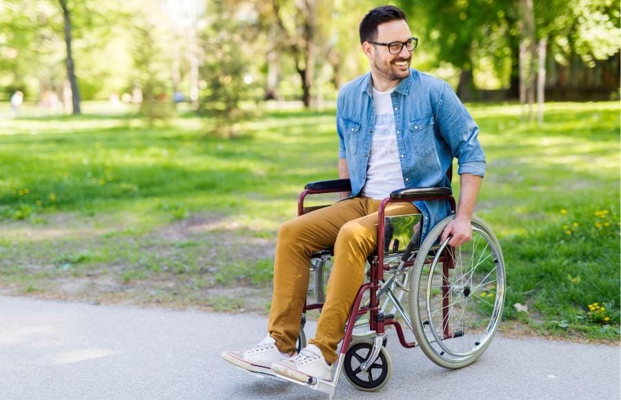 Young adult in a wheel chair smiling